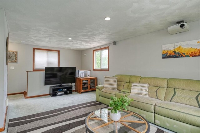 living room featuring carpet flooring, baseboards, a textured ceiling, and recessed lighting