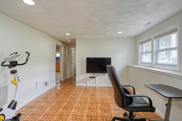 home office with baseboards, a textured ceiling, and recessed lighting