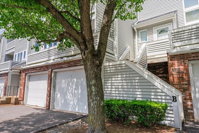 110 Burkhall St Unit B, Weymouth, MA 02190 - view of property exterior featuring brick siding and driveway