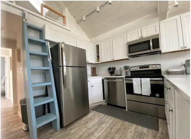 kitchen with lofted ceiling, light hardwood / wood-style flooring, stainless steel appliances, white cabinets, and wooden ceiling