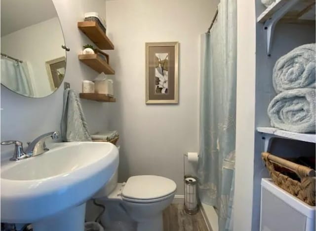 bathroom featuring sink, wood-type flooring, toilet, and a shower with shower curtain