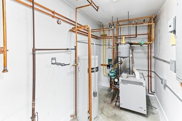 utility room featuring a heating unit and water heater
