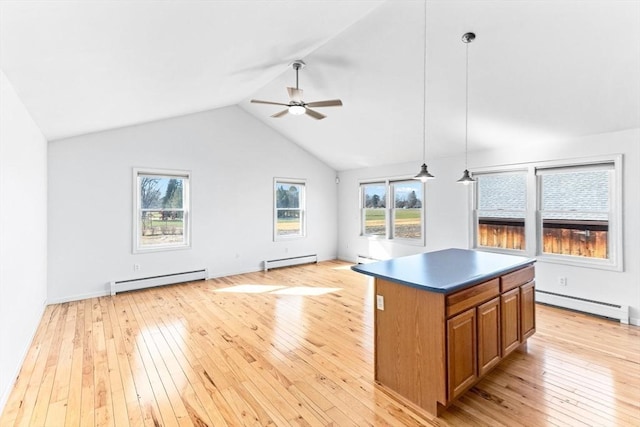kitchen with a baseboard heating unit, brown cabinets, and open floor plan