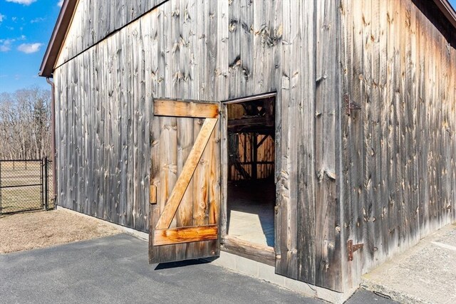 view of outbuilding featuring an outbuilding and fence