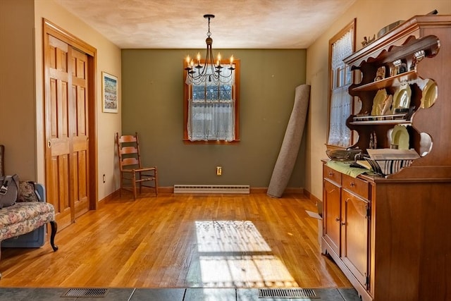 interior space with a chandelier and light hardwood / wood-style flooring