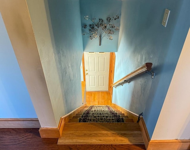 stairs featuring hardwood / wood-style flooring