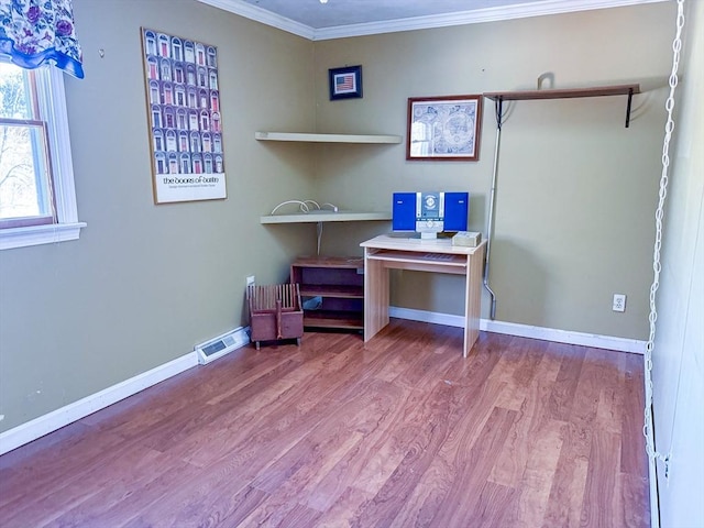 unfurnished office with hardwood / wood-style flooring and crown molding