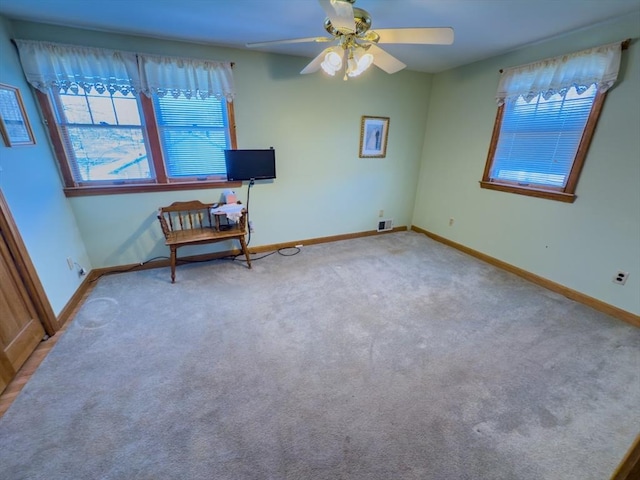 unfurnished room featuring ceiling fan and light colored carpet