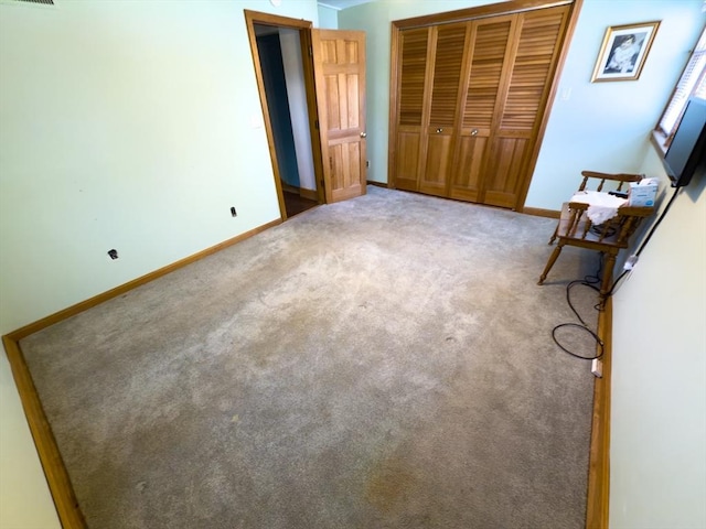 unfurnished bedroom featuring carpet floors and a closet