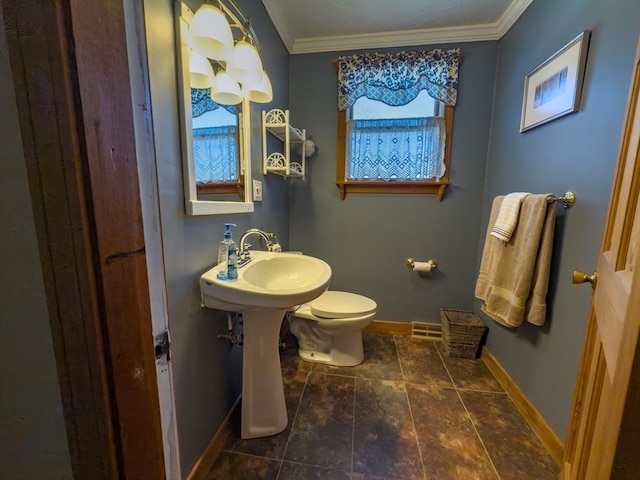 bathroom featuring crown molding and toilet