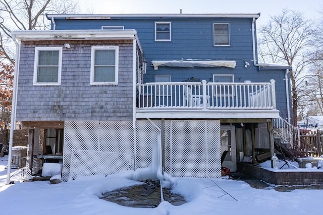 view of snow covered back of property