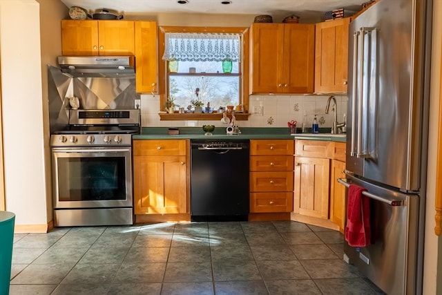 kitchen with backsplash, stainless steel appliances, sink, and dark tile patterned floors