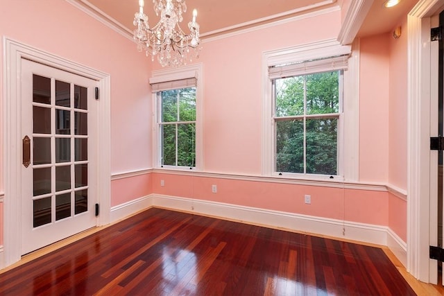 65 Central St, Andover, MA 01810 - unfurnished room featuring wood finished floors, a chandelier, baseboards, and crown molding