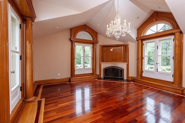 65 Central St, Andover, MA 01810 - unfurnished living room featuring lofted ceiling, plenty of natural light, a fireplace with flush hearth, a chandelier, and wood finished floors