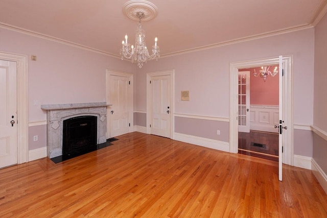65 Central St, Andover, MA 01810 - unfurnished living room with a chandelier, light wood-type flooring, a high end fireplace, and ornamental molding