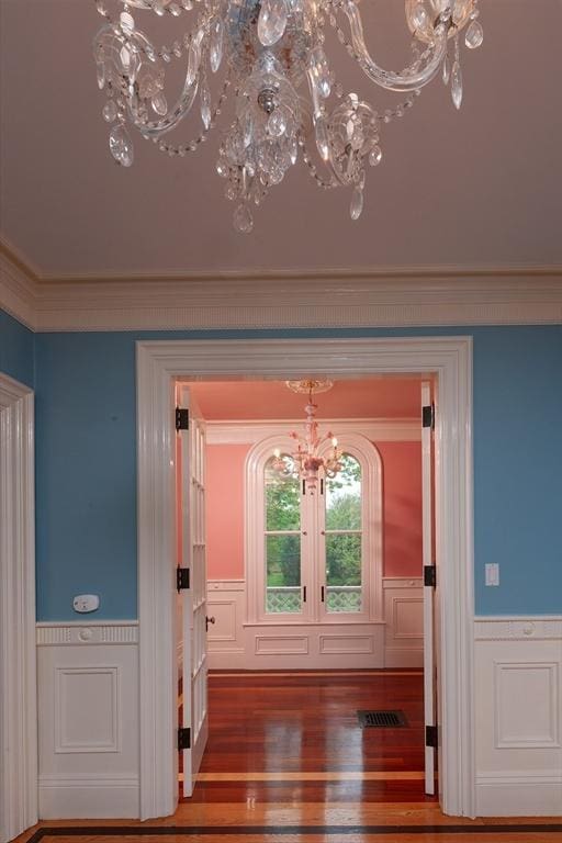 65 Central St, Andover, MA 01810 - entryway with a chandelier, french doors, wainscoting, wood finished floors, and ornamental molding