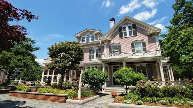 65 Central St, Andover, MA 01810 - view of front of home with a balcony, a chimney, and a porch