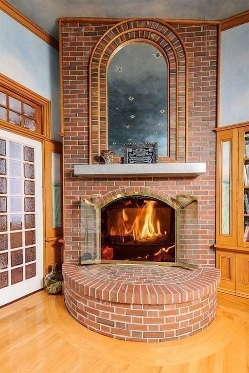 65 Central St, Andover, MA 01810 - detailed view of a fireplace, crown molding, and wood finished floors