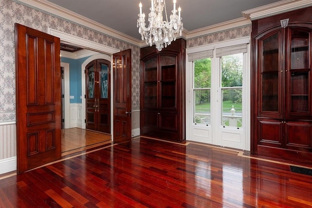 65 Central St, Andover, MA 01810 - interior space with wallpapered walls, hardwood / wood-style flooring, a wainscoted wall, a chandelier, and arched walkways