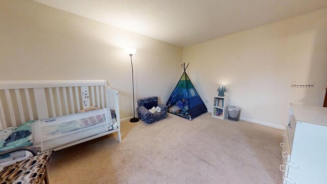 carpeted bedroom with baseboards