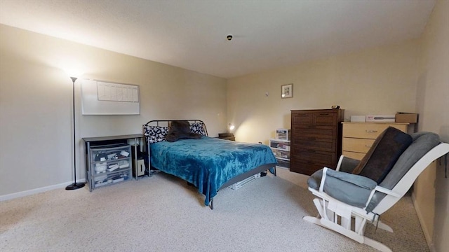 carpeted bedroom featuring baseboards