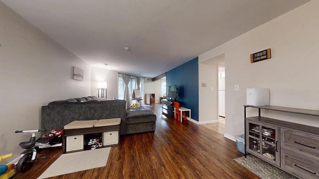 bedroom featuring wood finished floors, baseboards, and vaulted ceiling