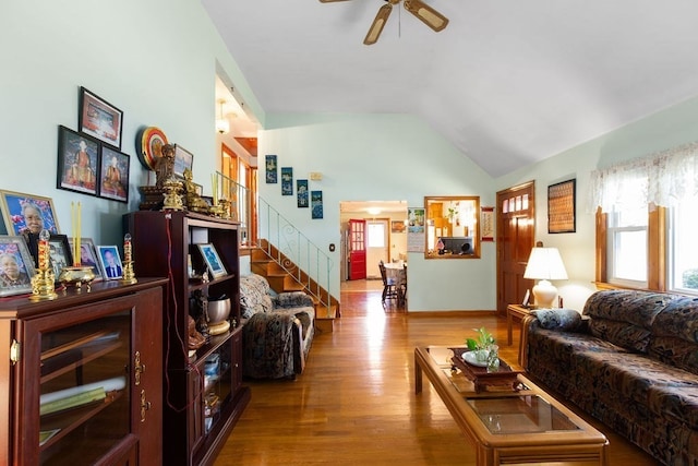 living room with lofted ceiling, hardwood / wood-style floors, and ceiling fan