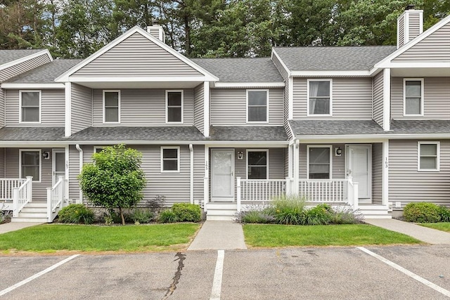 165 Bayberry Hill Ln Unit 165, Leominster, MA 01453 - townhome / multi-family property with a porch, uncovered parking, roof with shingles, and a chimney