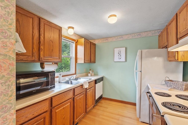 165 Bayberry Hill Ln Unit 165, Leominster, MA 01453 - kitchen with white appliances, brown cabinets, light countertops, and light wood-style flooring