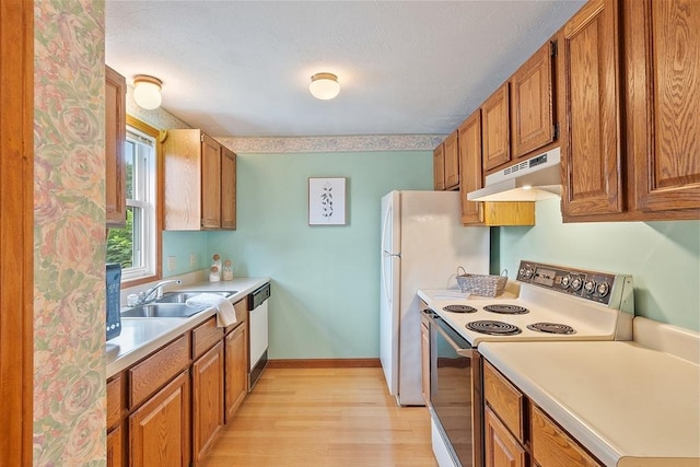 165 Bayberry Hill Ln Unit 165, Leominster, MA 01453 - kitchen with white appliances, under cabinet range hood, brown cabinets, and light wood-style floors