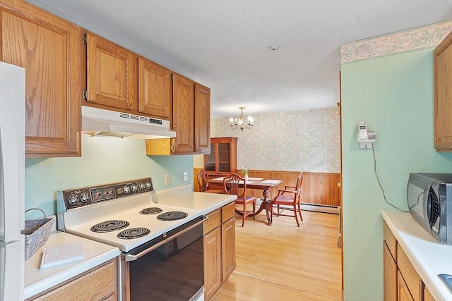 165 Bayberry Hill Ln Unit 165, Leominster, MA 01453 - kitchen with white electric range oven, under cabinet range hood, light countertops, light wood finished floors, and wallpapered walls