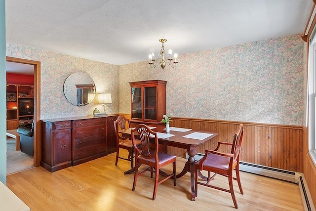 165 Bayberry Hill Ln Unit 165, Leominster, MA 01453 - dining area featuring wallpapered walls, a wainscoted wall, light wood-style floors, a chandelier, and baseboard heating