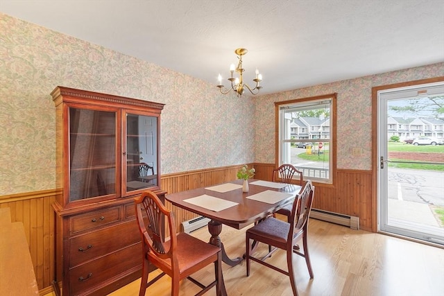 165 Bayberry Hill Ln Unit 165, Leominster, MA 01453 - dining area with a wainscoted wall, light wood-type flooring, a chandelier, baseboard heating, and wooden walls