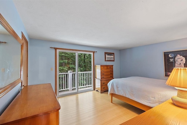 165 Bayberry Hill Ln Unit 165, Leominster, MA 01453 - bedroom with access to exterior, wood finished floors, and a wall mounted AC