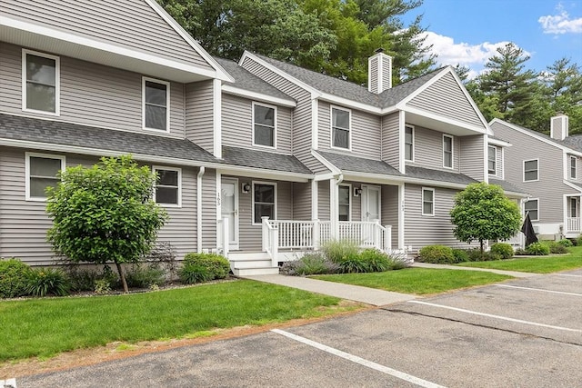 165 Bayberry Hill Ln Unit 165, Leominster, MA 01453 - townhome / multi-family property with covered porch, a shingled roof, uncovered parking, and a front lawn
