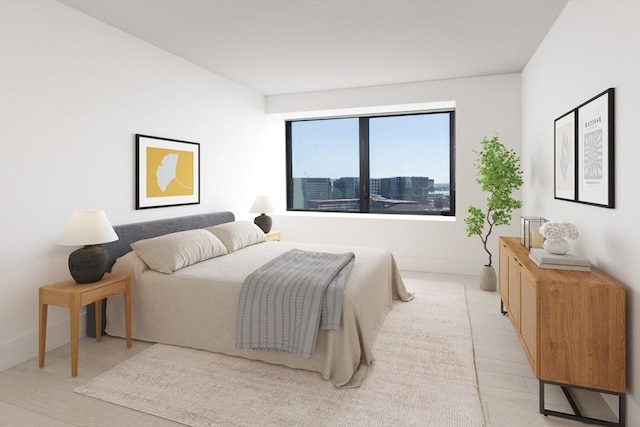 bedroom with light wood-style floors and baseboards
