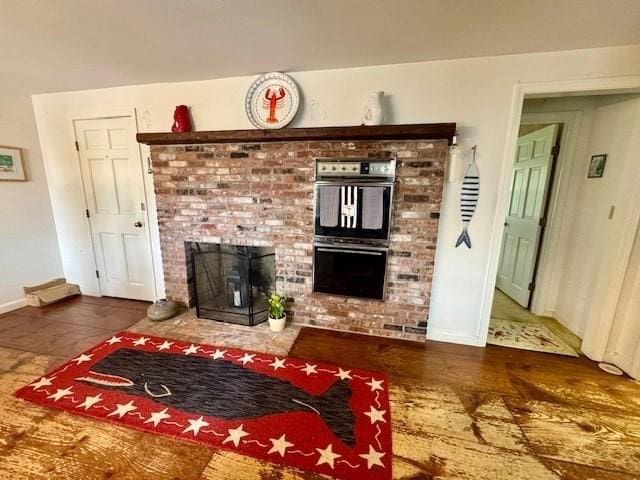 living room with baseboards and a fireplace