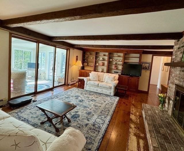 living room featuring dark wood finished floors, beam ceiling, and a fireplace