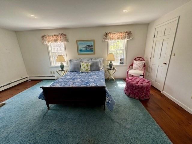 bedroom featuring baseboards and wood finished floors