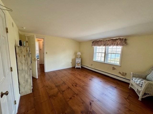 interior space with baseboards, a baseboard radiator, and wood-type flooring