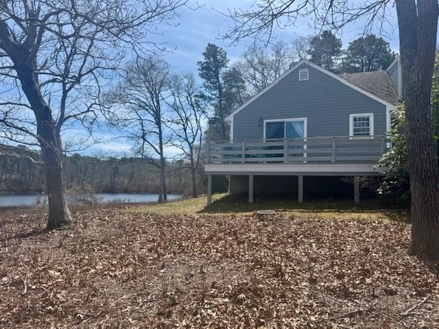 back of house featuring a deck with water view