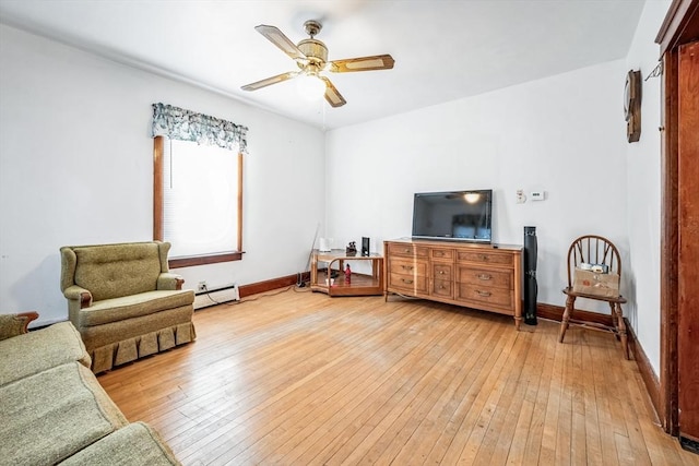 sitting room featuring baseboard heating, ceiling fan, and light hardwood / wood-style flooring