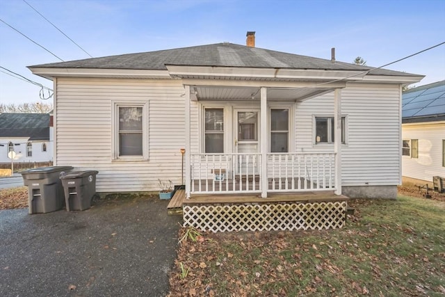 rear view of house with covered porch