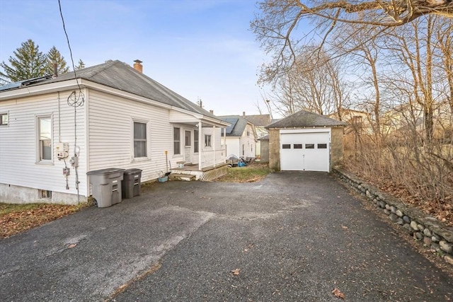 view of front of home featuring a garage and an outdoor structure