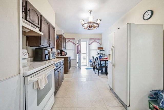 kitchen featuring dark brown cabinets, white appliances, and an inviting chandelier