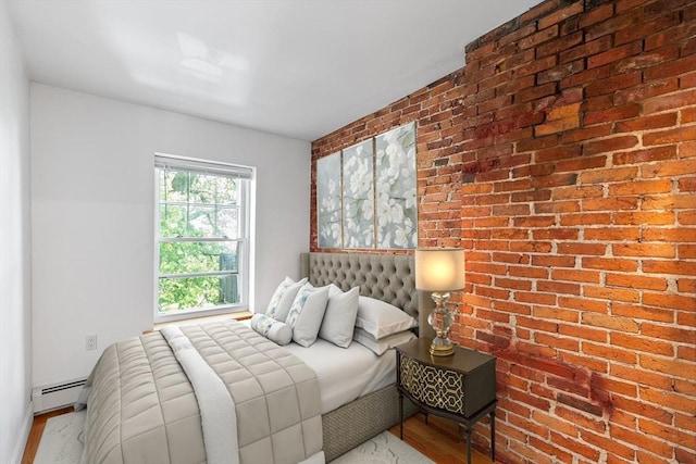 31 Division St # 3, Chelsea, MA 02150 - bedroom with baseboard heating, wood finished floors, and brick wall