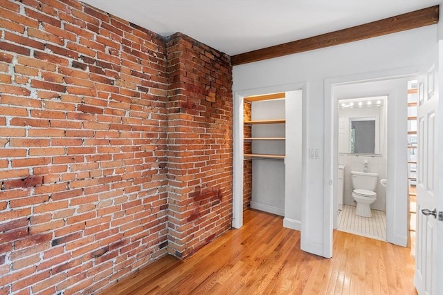 31 Division St # 3, Chelsea, MA 02150 - unfurnished bedroom featuring light wood-style flooring, brick wall, and a closet