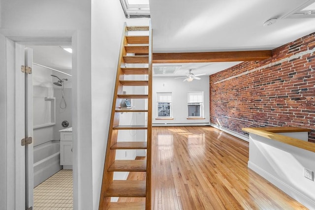 31 Division St # 3, Chelsea, MA 02150 - unfurnished living room featuring brick wall, a ceiling fan, light wood finished floors, beamed ceiling, and stairway