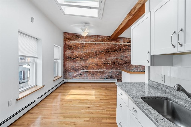 31 Division St # 3, Chelsea, MA 02150 - kitchen featuring a baseboard heating unit, white cabinetry, light wood-style floors, and beam ceiling