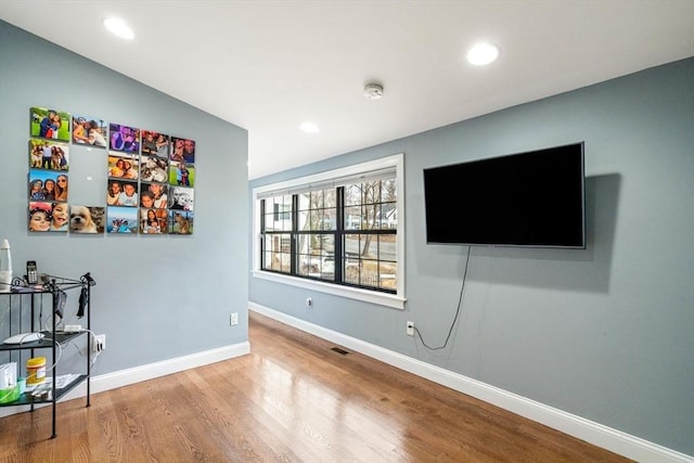 2171 Commonwealth Ave, Newton, MA 02466 - unfurnished living room with wood finished floors, baseboards, and recessed lighting